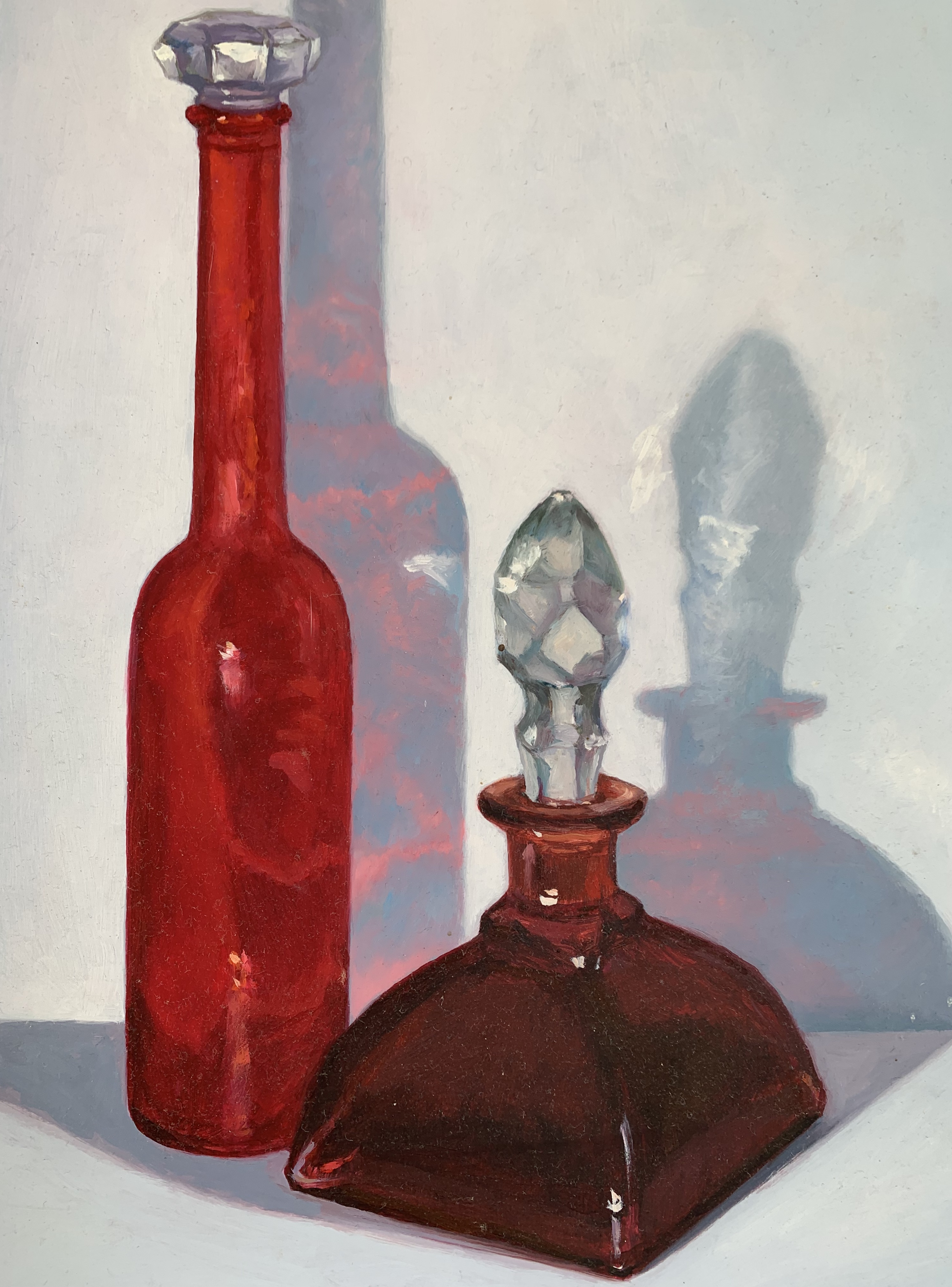 red glass bottles with shadows